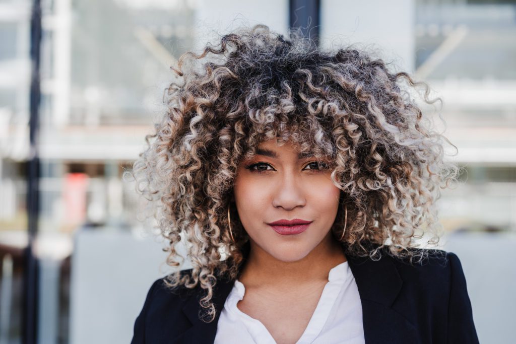 portrait of serious confident business woman in city. Business concept