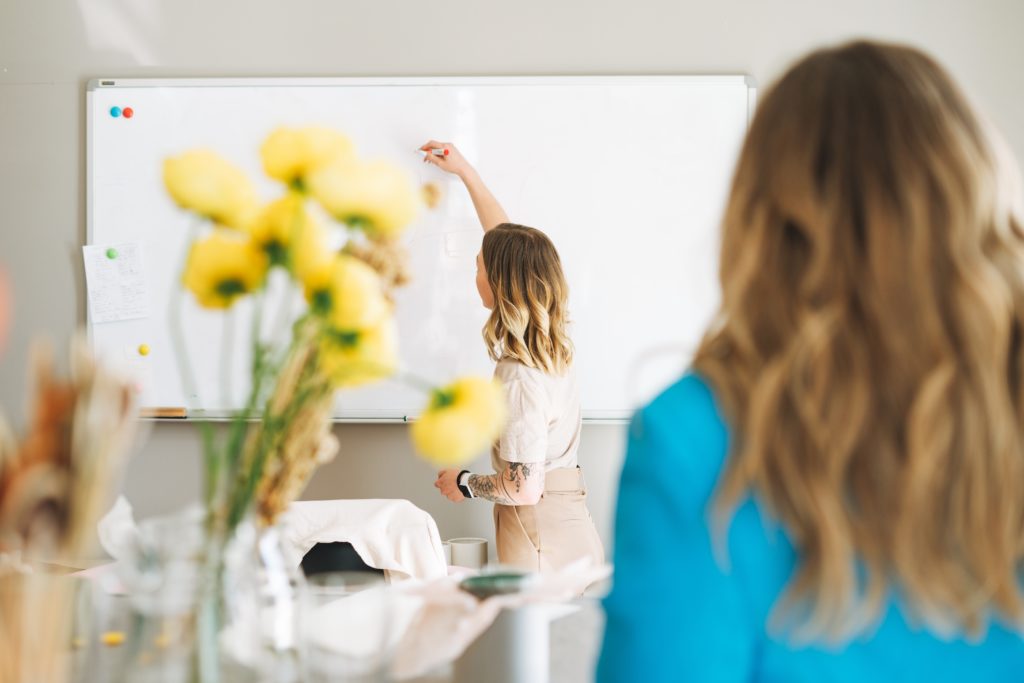 Young blonde woman on lecture in a classroom